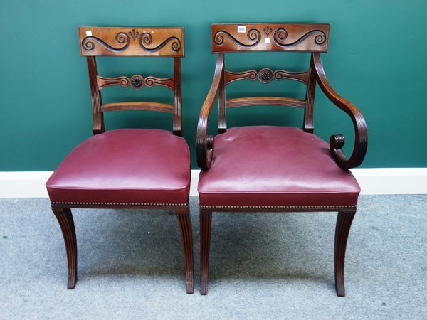 A set of eight early 19th century mahogany framed dining chairs, each with carved crest and bullseye waist rail, on sabre supports, including pair of