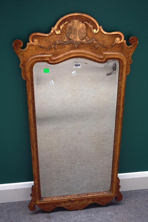 A George I style gilt framed wall mirror with shell moulded upper frieze and shaped bevelled mirror plate, 57cm wide x 114cm high.