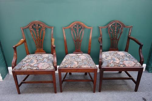 A set of seven George III mahogany framed dining chairs, with Prince of Wales feathers splat, on tapering square supports, together with a similar car