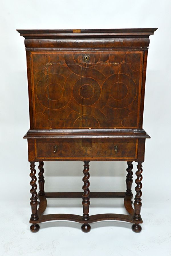 A 17th century and later oyster veneered escritoire, the drop front revealing a fitted interior, the associated stand with one long drawer on barleytw