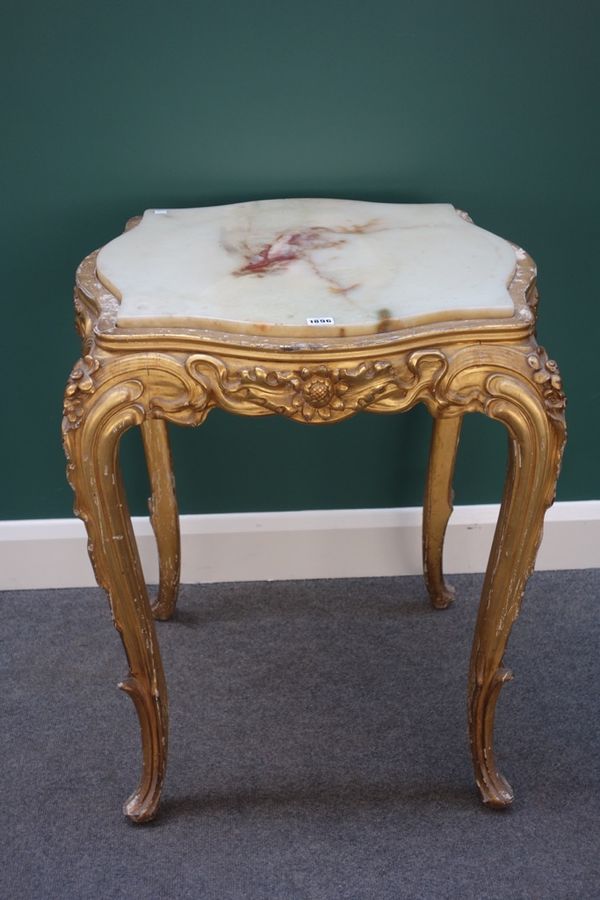 A Louis XV style centre table, the onyx inset serpentine top on a floral moulded gilt base with four cabriole supports, 66cm wide.