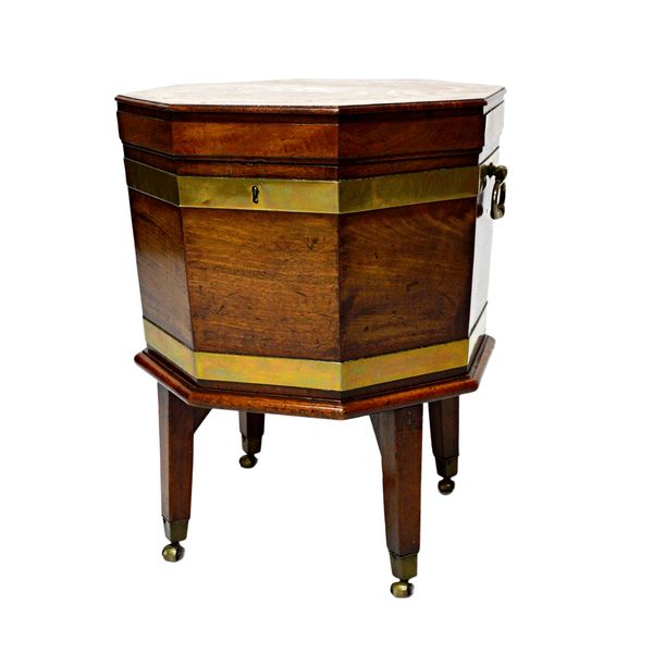 A George III brass bound mahogany octagonal cellarette on stand, 46cm wide x 59cm high. Illustrated