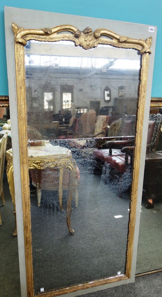 A 19th century parcel gilt green painted rectangular wall mirror, the moulded frame about the two part mirror plate, 73cm wide x 158cm high.