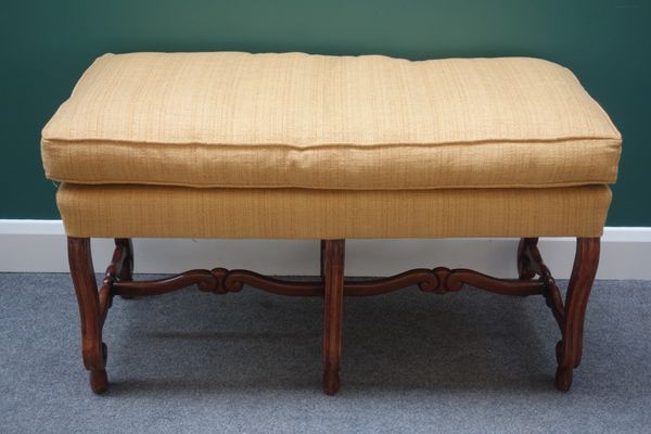 A 17th century style walnut framed rectangular footstool, on six scroll supports united by shaped stretcher, 102cm wide, together with an early 20th c