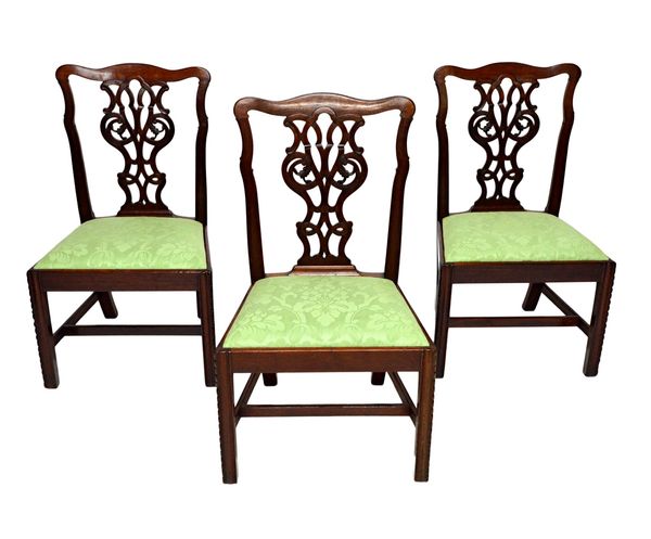 A set of ten mahogany framed dining chairs in the Chippendale style, each with serpentine crest over pierced splat over straight front seat, on channe