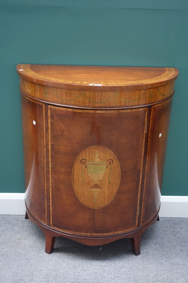 A George III style satinwood and marquetry inlaid mahogany demi-lune side cabinet, with single door, on splayed feet, 84cm wide.