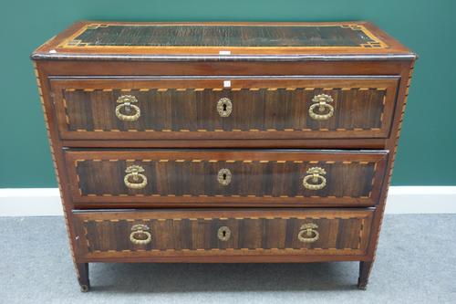 A late 18th century German rosewood mahogany and satinwood commode, with three long drawers, on gilt metal mounted canted square supports, 113cm wide.