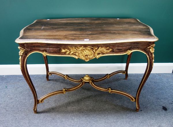 A Louis XV style parcel gilt brown painted centre table of serpentine outline, with single frieze drawers, on cabriole supports united by shaped stret