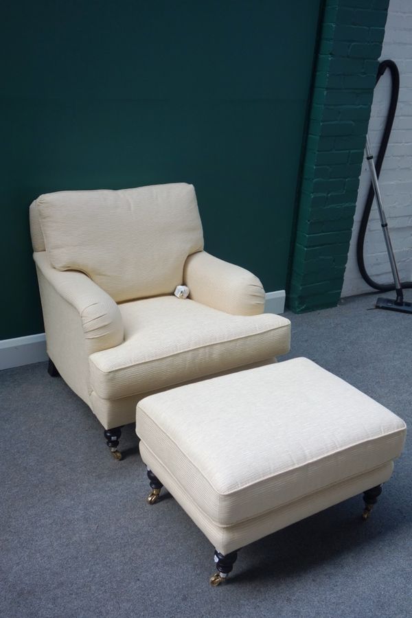 'Gotz Ardnt'; a near pair of 20th century cream upholstered easy armchairs, together with a matching footstool, all on turned supports. (3)