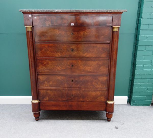 An Austrian Empire mahogany chest, the grey marble top over six frieze drawers, flanked by gilt metal mounted split turned columns, 125cm wide x 153cm