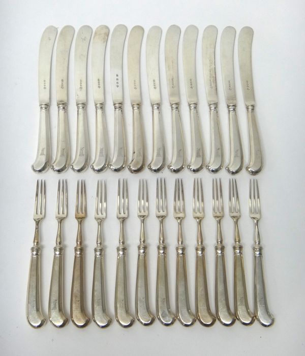 Eleven silver dessert or fruit knives, London 1928, another example, London 1931 and twelve dessert or fruit forks, London 1928, each with a pistol gr