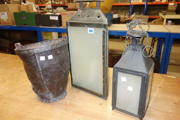 An 18th century leather fire bucket and two 20th century lanterns, (3).