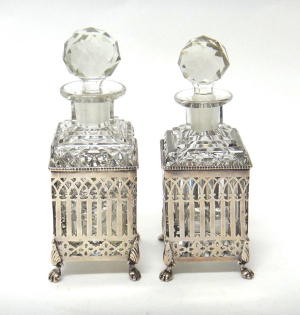 Two similar silver scent bottle frames, each of square form, having pierced arcaded decoration, beaded rim and raised on four paw feet, Birmingham 191