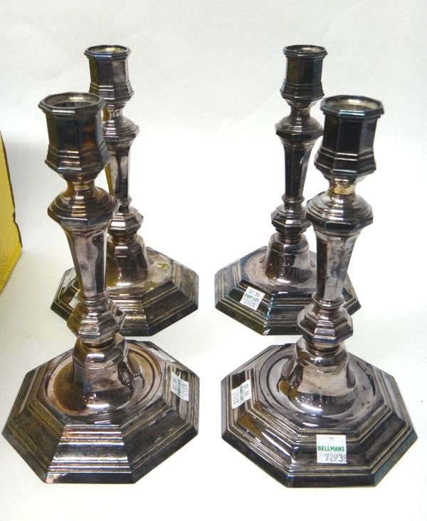 A set of four French plated table candlesticks, detailed Christofle France, each with a tapered octagonal stem and on an octagonal foot, a teapot, a s