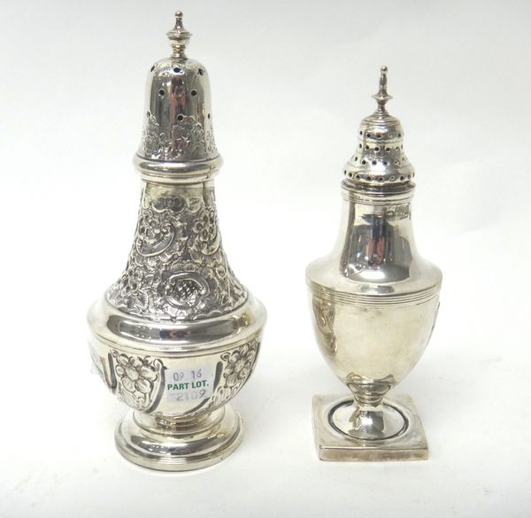 A silver sugar caster, the urn shaped body decorated with a reeded band and raised on a square base and a silver larger sugar caster, with floral and