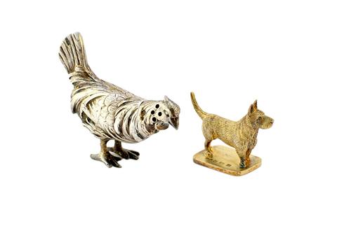 A silver pepperette modelled as a cockerel, import mark London 1926, 5.8cm long and a silver gilt model of a standing terrier, on a rectangular base,