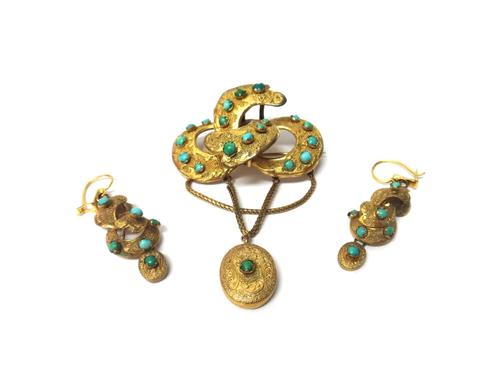 A Victorian gilt metal and turquoise set brooch, in a scrolling design, with an engraved and textured finish, the front with an oval pendant drop and