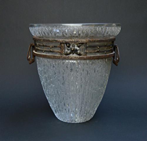 A sapphire and diamond set cluster ring, claw set with the oval cut sapphire at the centre and otherwise mounted with circular cut diamonds, ring size