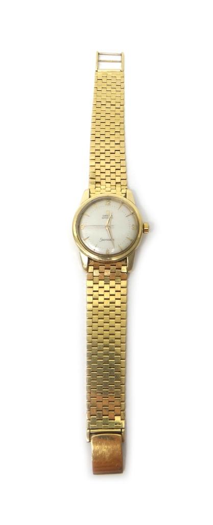 A gentleman's gold Omega Seamaster Automatic bracelet wristwatch, the signed circular silvered dial with gilt Arabic and arrow shaped numerals, centre