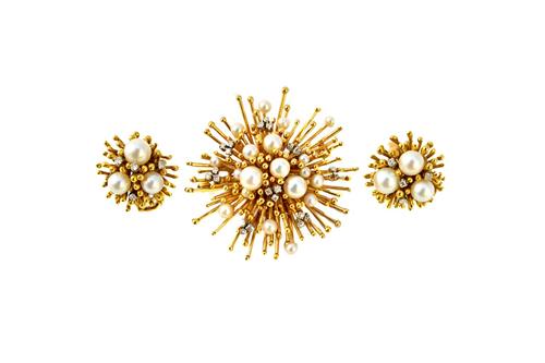 A gold, diamond and cultured pearl set brooch, designed as a starburst, mounted with a variety of sizes of cultured pearls and with small circular cut