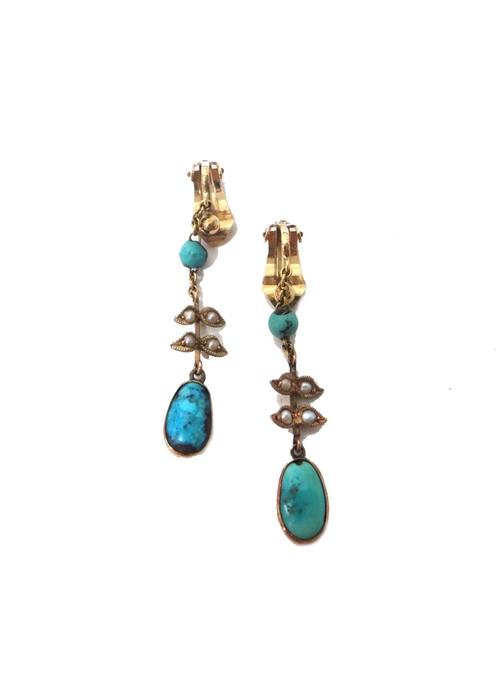 A pair of turquoise and seed pearl pendant earrings, each with the principal oval turquoise to the drop and with seed pearl set foliate divisions and