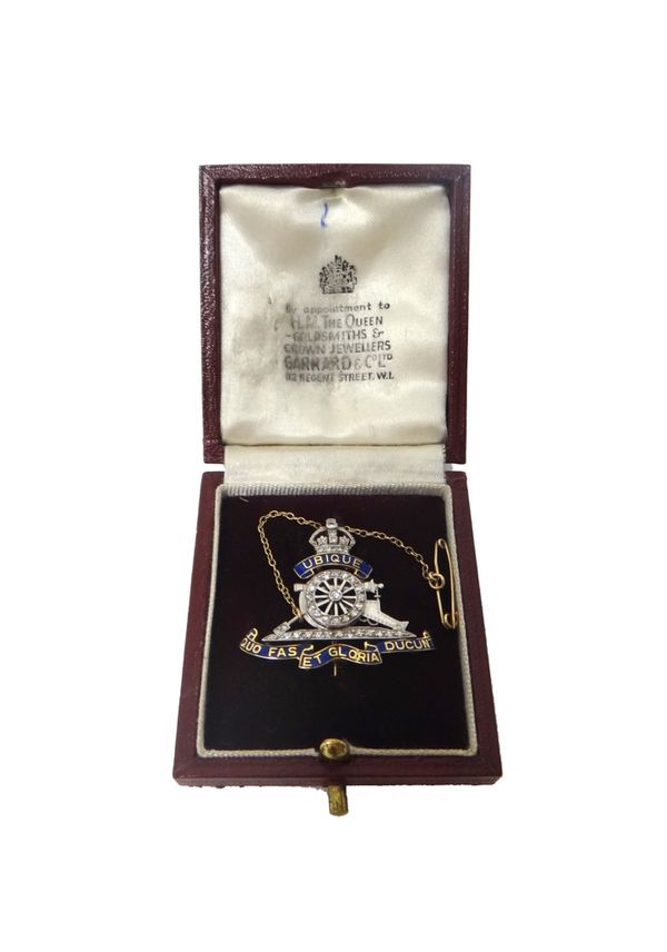 A two colour gold diamond set and enamelled military brooch, designed as the badge of The Royal Artillery, pre 1953, mounted with circular cut diamond