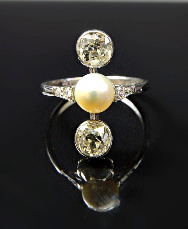 A white gold and platinum ring, mounted with a cultured pearl at the centre, between the two principal collet set cushion shaped diamonds, between dia
