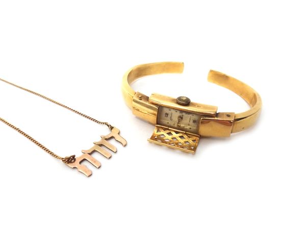 A lady's gold bangle wristwatch, detailed 0,750, gross weight excluding the movement 10 gms and a gold necklace, with a Hebrew motif, indistinctly mar