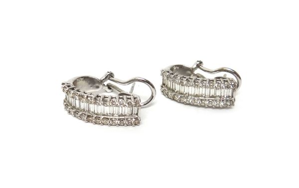 A pair of white gold and diamond set earclips, each designed as a row of baguette diamonds at the centre, between two rows of circular cut diamonds, d