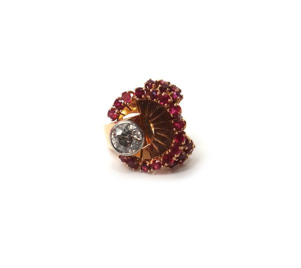A gold, diamond and synthetic ruby set cocktail ring, collet set with the principal cushion shaped diamond in a semi-circular surround of circular cut