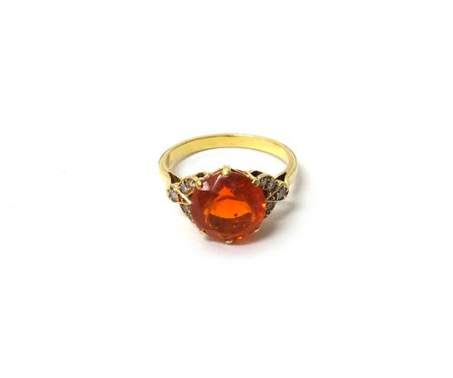 A gold, fire opal and diamond set ring, claw set with the circular cut fire opal at the centre, between diamond set five stone V shaped shoulders, rin