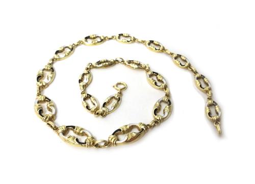 A European gold, black and white enamelled necklace, in a graduated oval link design, having scrolled motifs, on a boltring clasp, length 42.5cm, gros
