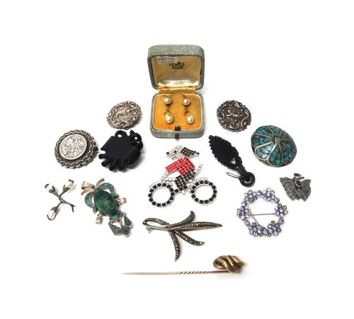 A group of Jewellery, comprising; a Butler and Wilson brooch, designed as a dog on a bicycle, seven further brooches, a carved green stone pendant des