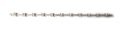 An 18ct white gold and diamond set bracelet, in a bar link design, with 'X' shaped motifs at intervals, mounted with a row of circular cut diamonds to
