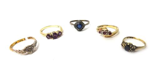 A 9ct gold, ruby and diamond set ring, in a twistover design, a gold and platinum ring, mounted with a circular cut diamond, a gold and amethyst set t