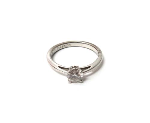 A platinum and diamond set single stone ring, claw set with a circular cut diamond by Mappin & Webb, 999 Platinum grade, London 2003, ring size N, wit
