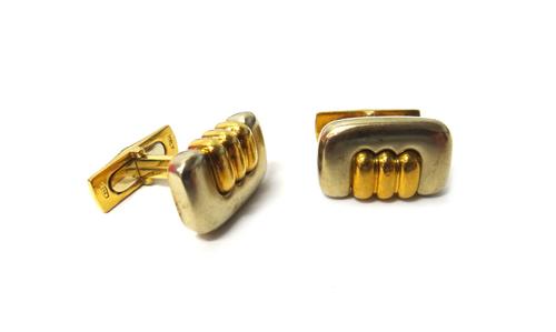 A pair of Italian yellow and white gold cufflinks, each curved rectangular front with a triple section central ridged motif, the backs with folding cl