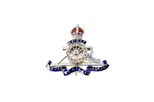 A white gold and platinum, diamond set and enamelled military sweetheart's brooch, designed as the badge of The Royal Artillery, detailed 18 CT, PLAT.
