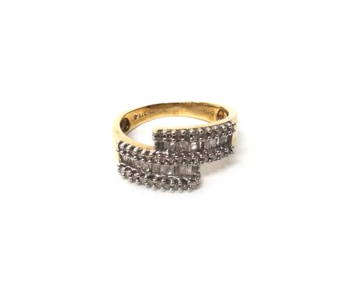 A 9ct gold and diamond set ring, mounted with rows of baguette diamonds at the centre, between rows of baguette diamonds to the sides, in a twistover