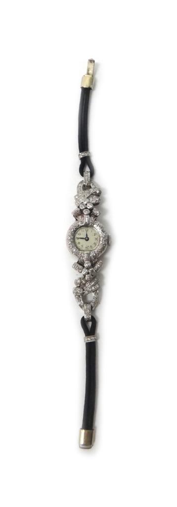 A lady's diamond set dress wristwatch, with an associated jewelled Swiss movement, the case surround and the strap mountings set with circular cut and