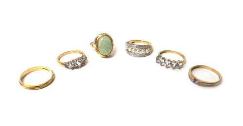 A 14ct gold ring, mounted with a carved oval jade, an 18ct gold wedding ring, a 9ct gold ring, mounted with a row of cultured pearls at the centre, be