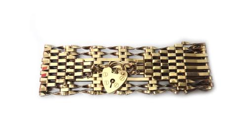 A 9ct gold, bar, twisted bar and oval link gate bracelet, on a 9ct gold heart shaped padlock clasp, weight 16.5 gms.