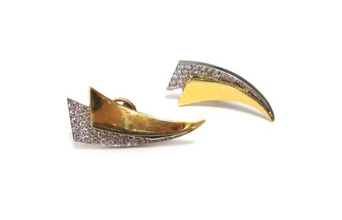 A pair of two colour gold and diamond set earrings, each in a curved twin triangular shaped design, mounted with circular cut diamonds, the backs with