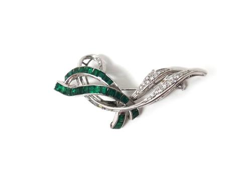 An white gold, emerald and diamond set brooch, designed as a spray, mounted with baguette and circular cut diamonds and with calibre cut emeralds, det