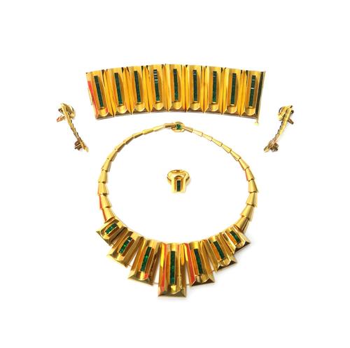 An Eastern gold and green gem set demi parure, comprising; a wide bracelet, a graduated collarette, a pair of earrings and a ring, each in a geometric