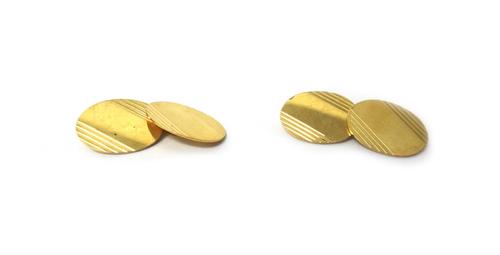 A pair of 18ct gold cufflinks, with oval backs and fronts having banded decoration, Birmingham 1958, weight 9 gms.