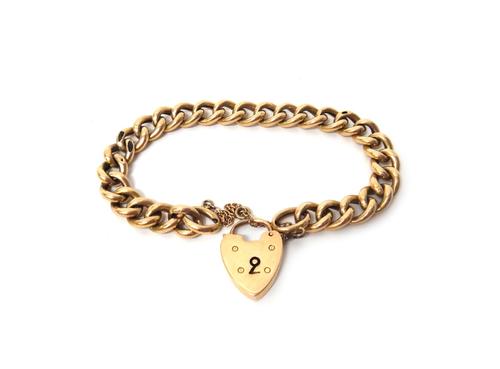 A gold hollow curb link bracelet, with a gold heart shaped padlock clasp, detailed 15, weight 16.5 gms.