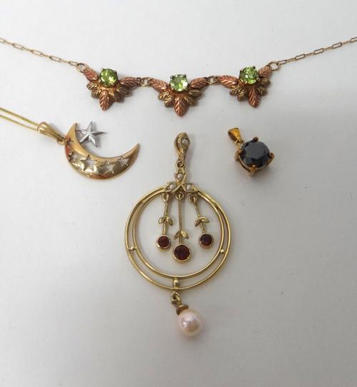 A 9ct two colour gold and peridot set necklace, the front with three peridot set foliate motifs, a 9ct two colour gold pendant, designed as a crescent