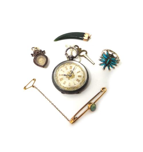 A gold and opal set single stone bar brooch, collet set with an oval opal, fitted with a safety chain, a garnet set pendant locket of drop shaped form