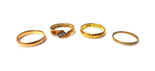 An 18ct gold band ring, mounted with a row of three cushion shaped diamonds in a twistover design, Birmingham 1913, gross weight 4 gms, a 22ct gold we